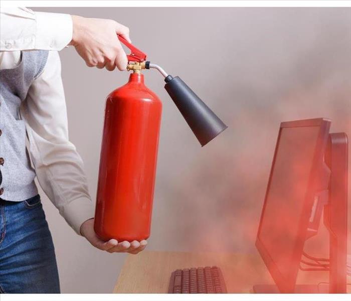 Man using fire extinguisher to stop fire in the office. Concept of protection and security