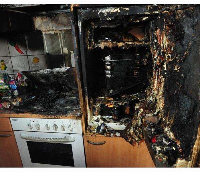 Stove damaged by fire. Burnt kitchen