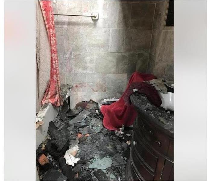 Debris from fire in a bathroom.