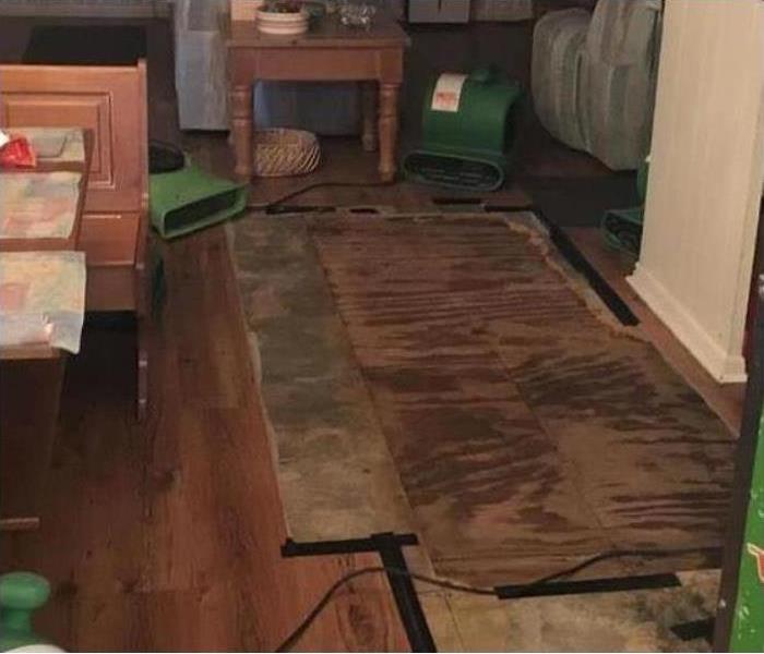 Air movers drying wooden floor