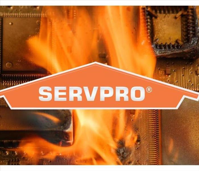 Background of an electronic on fire with SERVPRO logo on front of the picture